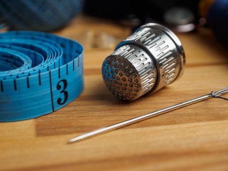 Close-up of a sewing needle and thimble. Detailed images of sewing tools highlighting their quality...