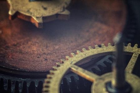 Macro close-up of the gear mechanism: detailed teeth of metal gears, shiny surfaces, complex...