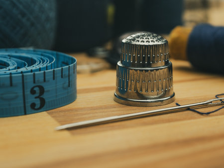 Close-up of a sewing needle and thimble. Detailed images of sewing tools highlighting their quality...