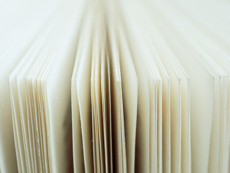 Close-up of open book pages filled with text. An ideal image for themes of literature, reading and...