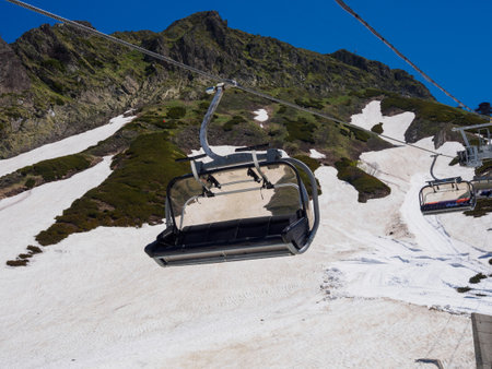 The cable car glides over picturesque mountain scenery, offering breathtaking views and an atmosphere of adventure at altitude.の写真素材