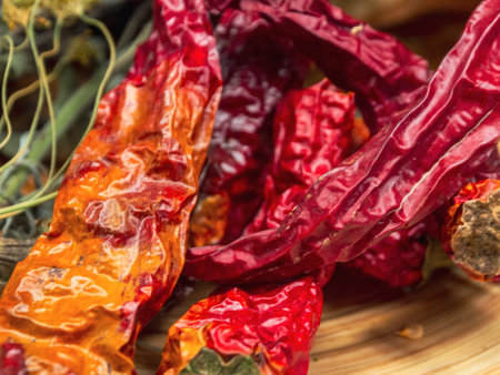 Dried hot red peppers on a textured background, highlighting the vibrant color and detail of the spice.の写真素材