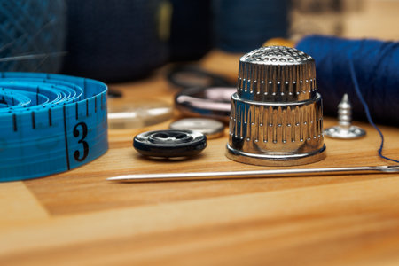 Close-up of a sewing needle and thimble. Detailed images of sewing tools highlighting their quality...