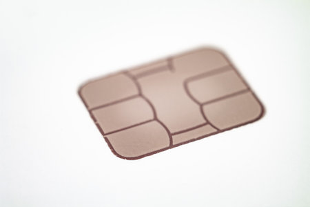 Close-up of a bank card chip demonstrating contactless payment capabilities.の写真素材