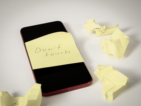 Smartphone with a âDo Not Touchâ sticker: a symbol of a break from digital devices, reminding you of the importance of unplugging and taking a break.の写真素材