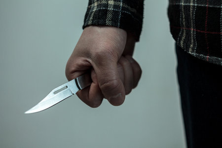 A man with a knife in his hand.の写真素材