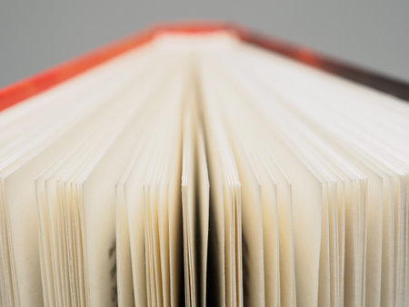 Close-up of open book pages filled with text. An ideal image for themes of literature, reading and knowledge.の写真素材