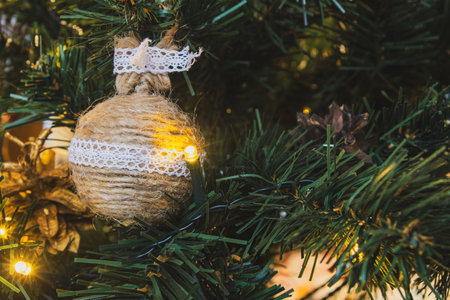 Colored Christmas decorations sparkle merrily on the Christmas tree, creating an atmosphere of magic and festive coziness.の写真素材