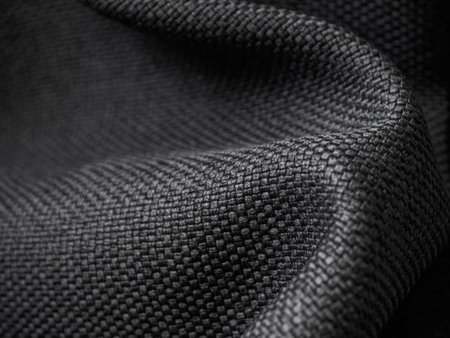 Macro photography of dark fabric, highlighting its texture and depth of color, creating an...
