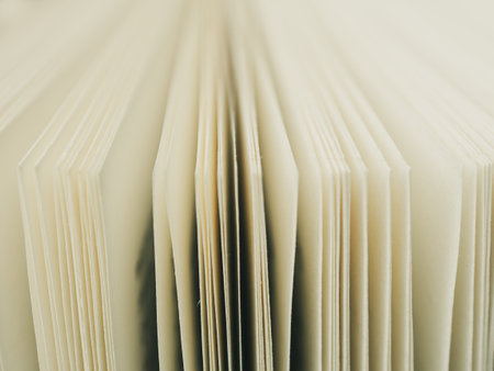 Close-up of open book pages filled with text. An ideal image for themes of literature, reading and knowledge.の写真素材