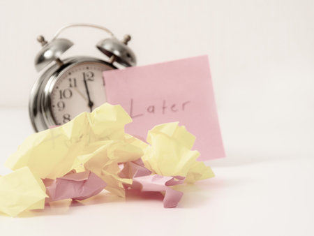 Crumpled pieces of paper against the background of the inscription âlaterâ represent postponed tasks and a creative approach to time management.の写真素材
