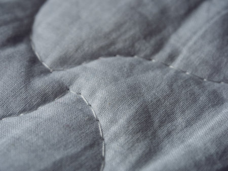 Macro photography of fabric texture, detailing soft waves and patterns, creating an impression of...