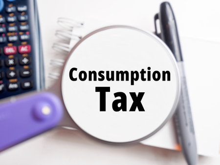 "Consumption Tax" text under magnification tax backgroundの写真素材