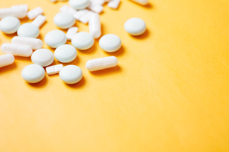 A variety of pills in the background: bright medicines and their packaging, representing the...