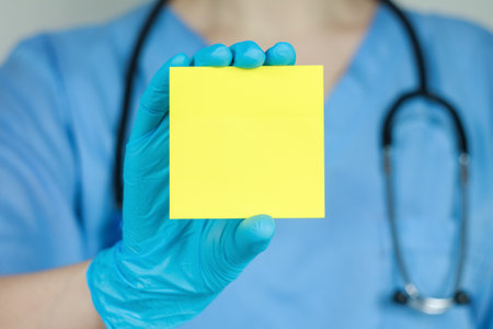 Doctor holding blank plaque offering free space for text or health and service information,...