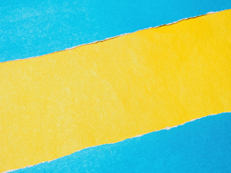 A textured background featuring torn paper edges creating a unique copy space. Rough, layered, and versatile for designs.の写真素材