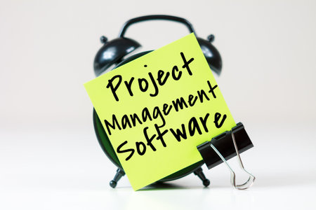 Project Management Software inscription on paper with alarm clock