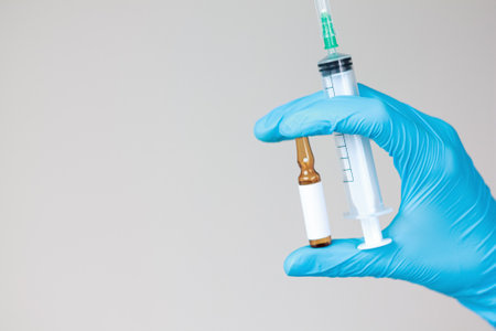 Doctor holding syringe and ampoule. Medical professional, injection, vaccine, medicine, healthcare,...