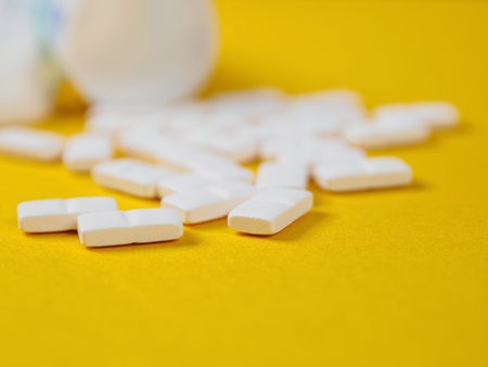 Pills of different shapes and colors on a spectacular background: Pharmaceuticals and the importance...