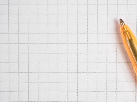 A close-up shot of a pen resting on a notepad, with ample free space in the background.の写真素材