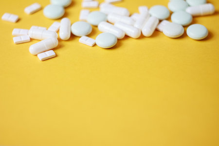 A variety of pills in the background: bright medicines and their packaging, representing the pharmaceutical industry and human health, close-up.の写真素材