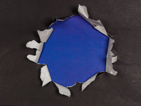 A textured background featuring torn paper edges creating a unique copy space. Rough, layered, and versatile for designs.の写真素材