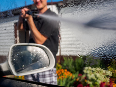 Manual Car Wash Using High Pressure Equipment To Effectively Remove Dirt And Protect The Coating, Close-Up.の写真素材