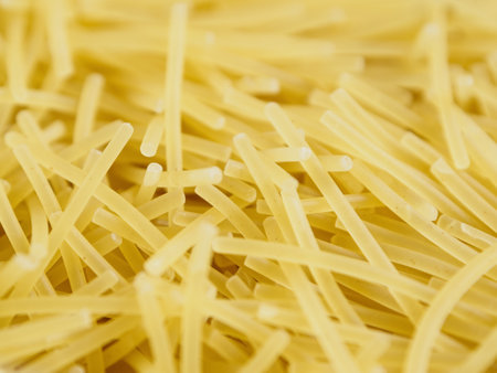 Close-up of small, thin vermicelli filini pasta. Delicate strands create a fine, textured food background. Light in color.の写真素材