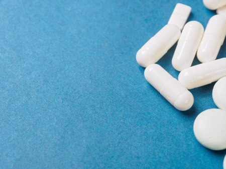 A variety of pills in the background: bright medicines and their packaging, representing the pharmaceutical industry and human health, close-up.の写真素材