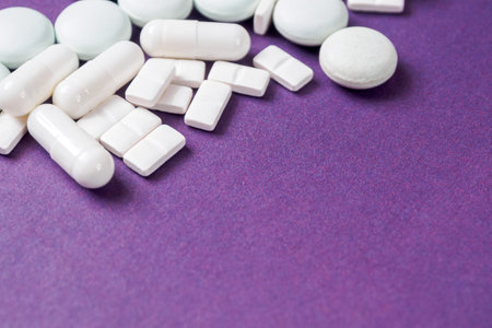 Macro Photography of Different Pills in the Background: Visual Representation of Drugs and Their Role in the Pharmaceutical Industry, Close-Up.の写真素材