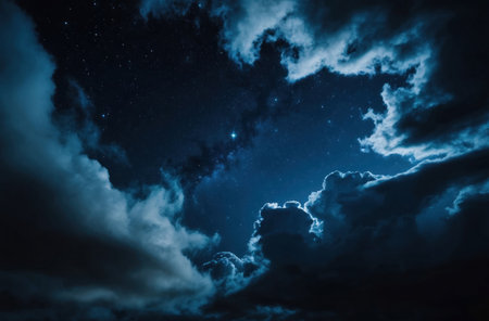 A mystical midnight sky filled with stars and surrounded by dramatic clouds, creating a dark and enchanting natural background with a night starry and cloudy sky.の素材