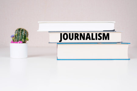 "Journalism" inscription books backgroundの写真素材