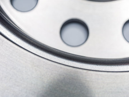 Close-up detail of a metal brake disc, showing intricate patterns and textures. Industrial, metallic, and mechanical.の写真素材