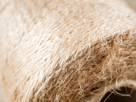 A close-up of a finely woven rope. The intricate texture and detail of the weave are clearly visible. Neutral tones.の写真素材