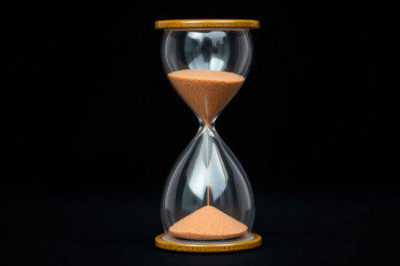 Hourglass close-up, black background. Time, deadline and concept of passing time. With copy space.の素材