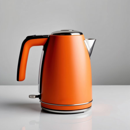 A vibrant orange electric kettle isolated on a clean background, perfect for kitchen or product design.の素材