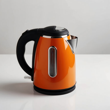 A vibrant orange electric kettle isolated on a clean background, perfect for kitchen or product design.の素材