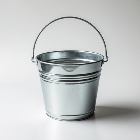 A single zinced bucket isolated on a clean background, showing its metallic texture and simple shape.の素材