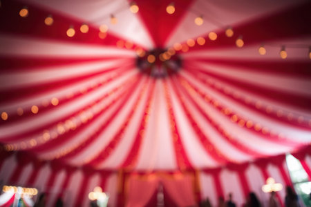A blurred view of a circus tent with colorful lights and striped fabric.の素材
