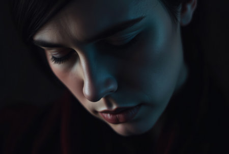A captivating portrait with deep shadows and subtle light, evoking emotion and introspection.の素材