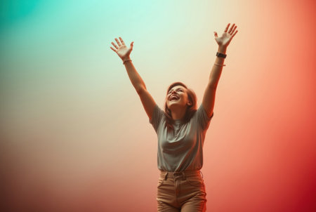 A young woman joyfully raises her arms towards the sky, radiating happiness and optimism.の素材