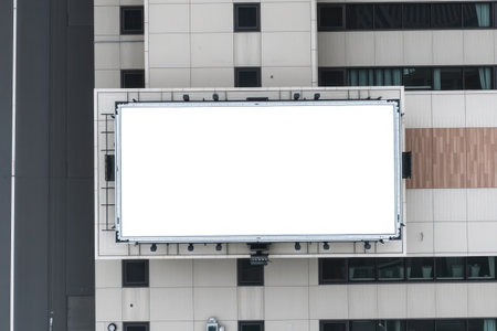 A large, blank white billboard is mounted on a building's roof.の素材