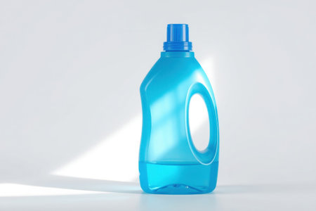 A translucent blue detergent bottle sitting on a white surface with light.の素材