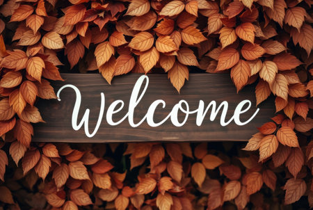 Welcome lettering on wooden signboard with autumn leaves background, vintage tonedの素材