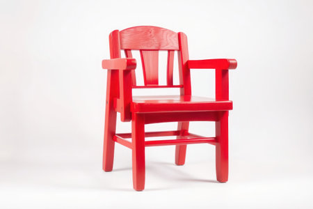 A vibrant red wooden chair sits elegantly against a white background.の素材
