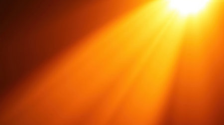 A dramatic, intense burst of golden sunlight radiating outwards against a dark background.の素材