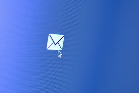 Close-up of a pixel cursor on a mail icon â digital communication.の素材