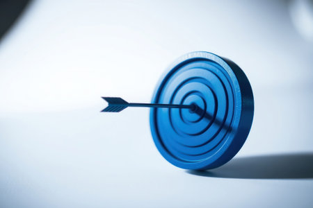 A blue target with an arrow pointing directly at the center.の素材