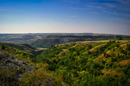 The sun setting behind the hilly Bayの写真素材