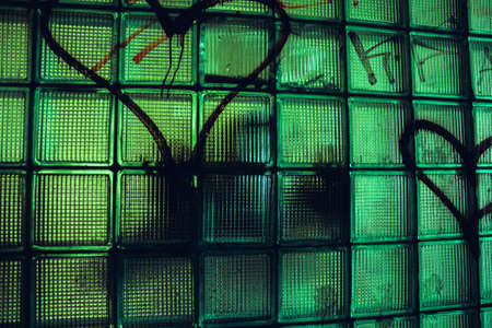 A gloomy silhouette beats through glassの写真素材